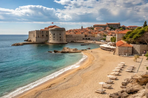 Banje Beach in Dubrovnik with medieval city walls and the Adriatic Sea