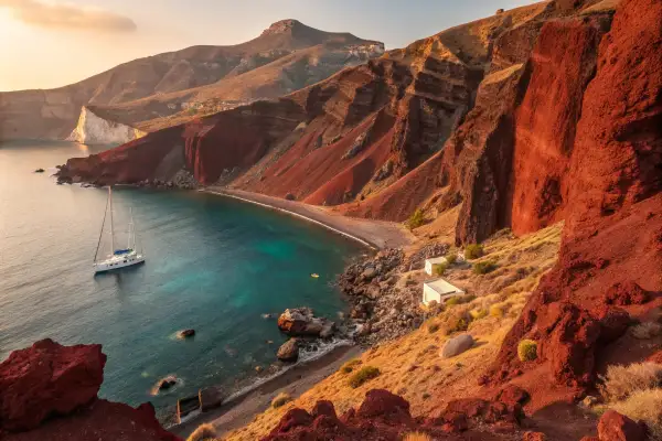 Red Beach in Santorini with red cliffs and turquoise waters under golden sunlight