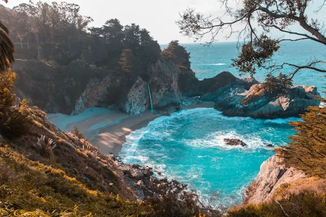 Hidden cove with turquoise waters and sea stacks at Secret Beach, Oregon.