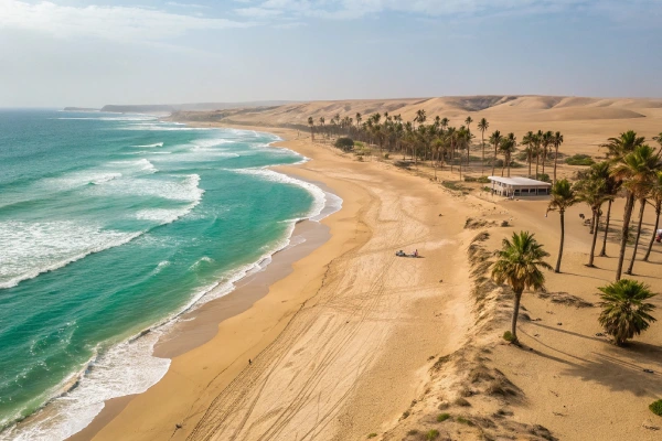 Long stretches of golden sand and clear turquoise water at Ica Beach in Peru, reflecting a calm and affordable coastal retreat.